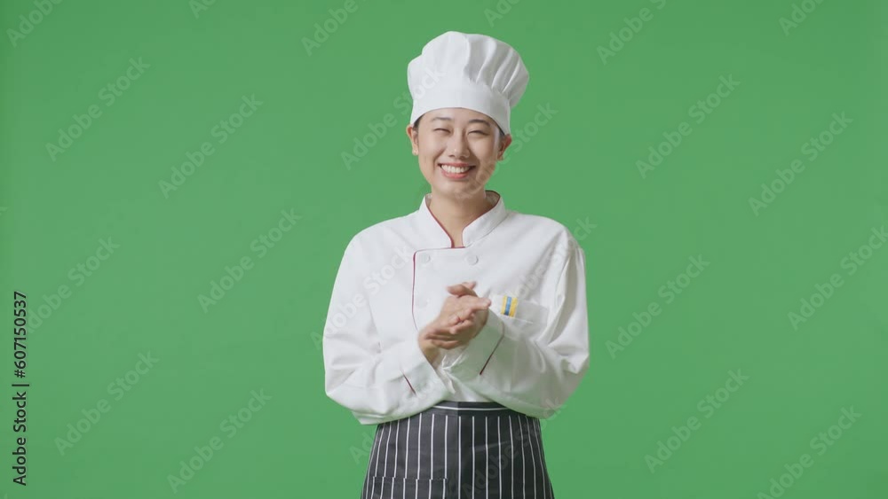 Asian Woman Chef Smiling And Clapping Her Hands While Standing In The Green Screen Background Studio
