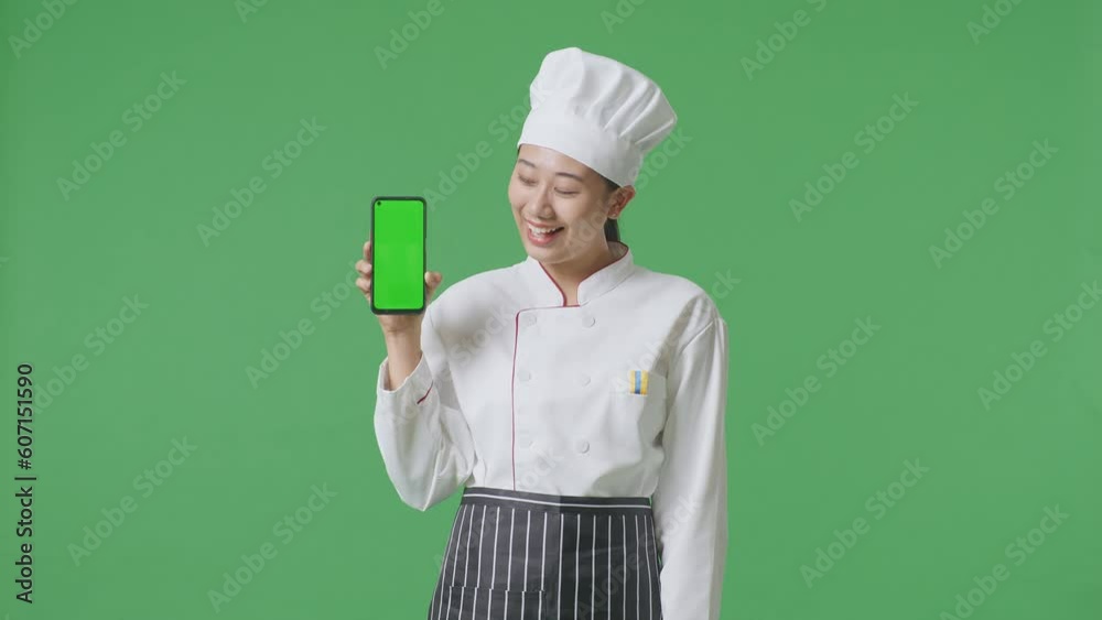 Asian Woman Chef Smiling And Showing Green Screen Smartphone To The Camera While Standing In The Green Screen Background Studio
Asian Woman Chef Smiling And Showing Green Screen Smartphone To The Camera While Standing In The Green Screen Background Studio