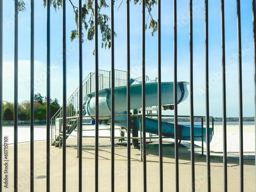 abandoned water slide behind a fence