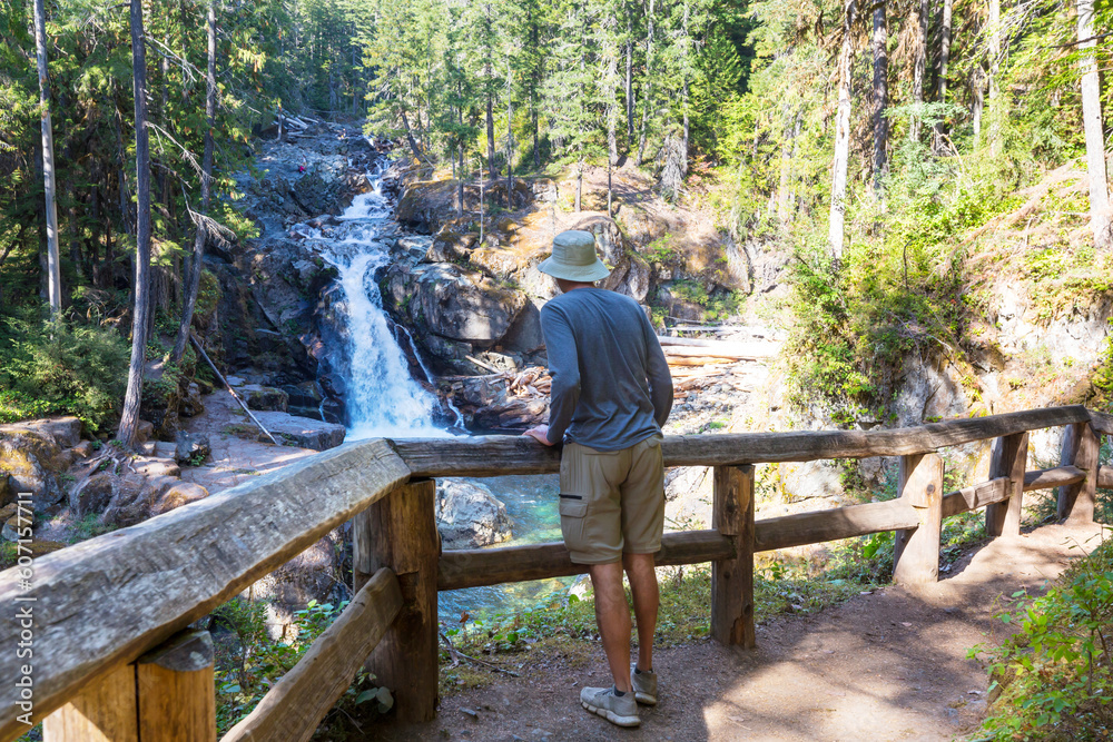Hiker near waterfall Hiker near waterfall