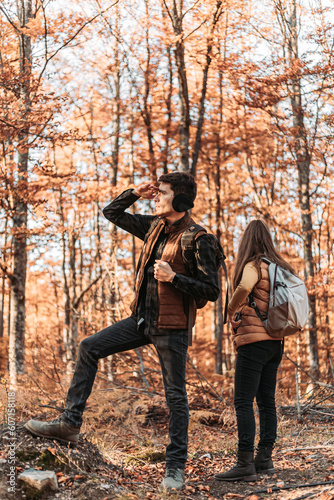 Young couple looking at something in the woods. Hiking, outdoors © stivog