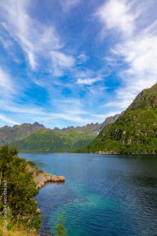Magnificent fjord in lofoten islands in norway with turquoise water and blue sky over high mountains Magnificent fjord in lofoten islands in norway with turquoise water and blue sky over high mountains