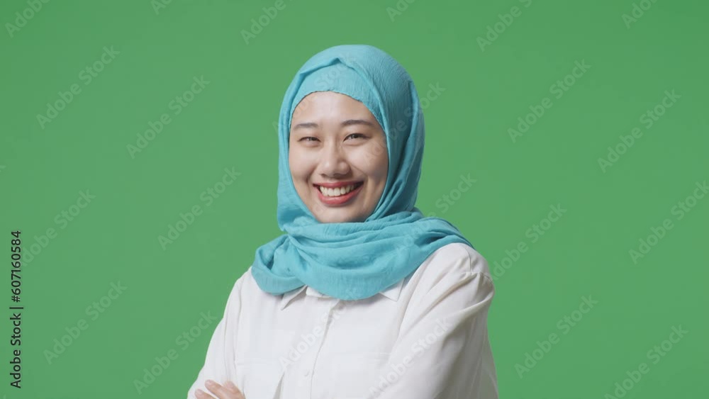 Close Up Side View Of Asian Muslim Woman Smiling And Crossing Her Arms While Standing In The Green Screen Background Studio
Close Up Side View Of Asian Muslim Woman Smiling And Crossing Her Arms While Standing In The Green Screen Background Studio