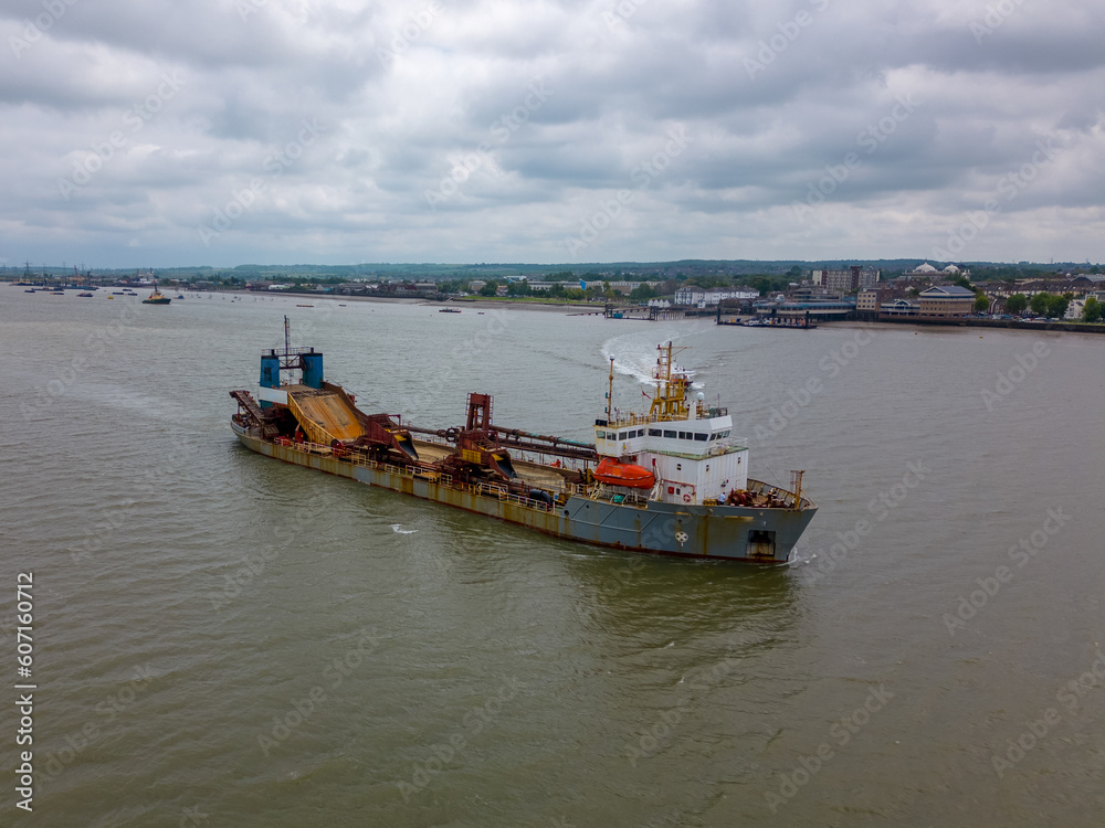 This aerial drone photo shows a cargo ship in the Tilbury docks. The vessel is sailing on the river Thames in England. 