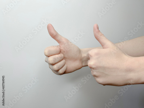 the hand gesture is a big paley up, expressing success on a light background photo