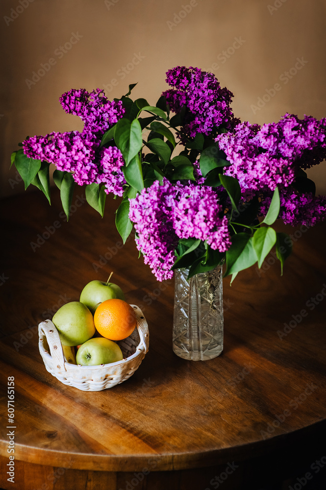 Still life lilac flowers in a vase on the table Stock Photo by