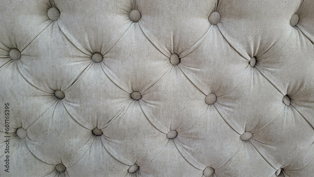 Grey velour background with quilted upholstery in Chesterfield style close-up. Grey velour background with quilted upholstery in Chesterfield style close-up.