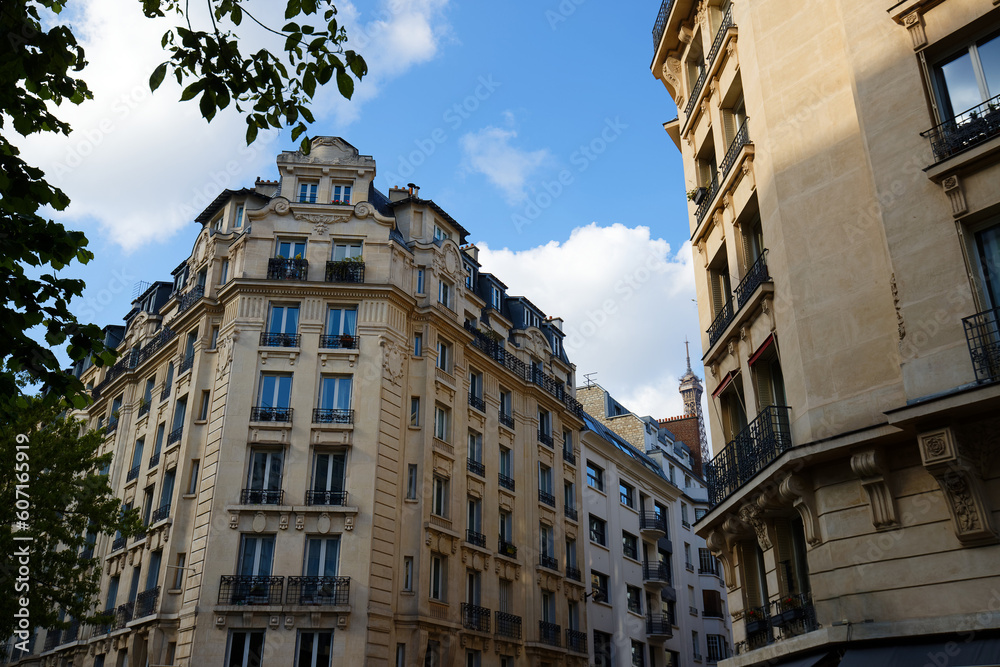 Obraz premium The facades of traditional French houses with typical balconies and windows. Paris.