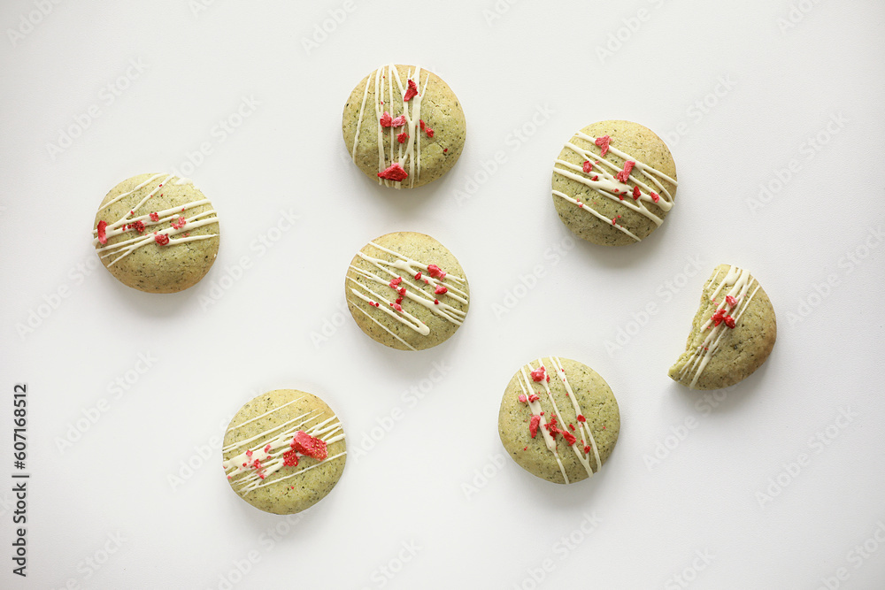 Composition with homemade mint gingerbread cookies with matcha and decorated sublimated strawberries and vanilla cream isolated on white background. Sugar, gluten and lactose free and vegan. Composition with homemade mint gingerbread cookies with matcha and decorated sublimated strawberries and vanilla cream isolated on white background. Sugar, gluten and lactose free and vegan.