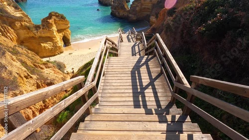 View of idyllic nature landscape with rocky cliff shore and waves crashing on. Camillo beach in Lagos. West Atlantic coast of Algarve region, south of Portugal.