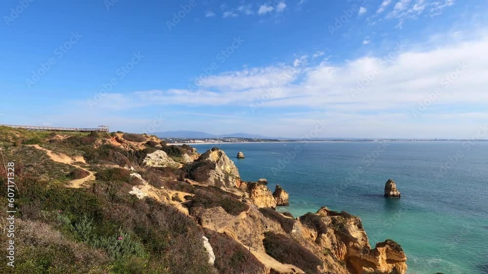 View of idyllic nature landscape with rocky cliff shore and waves crashing on. Camillo beach in Lagos. West Atlantic coast of Algarve region, south of Portugal. View of idyllic nature landscape with rocky cliff shore and waves crashing on. Camillo beach in Lagos. West Atlantic coast of Algarve region, south of Portugal.