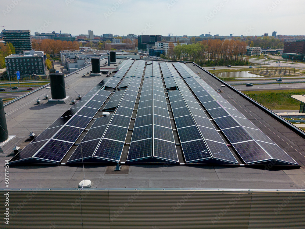 This aerial drone photo shows an office building rooftop with solar ...