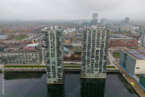 Aerial drone photo of two apartment buildings and a lake in Almere, Flevo the Netherlands. 