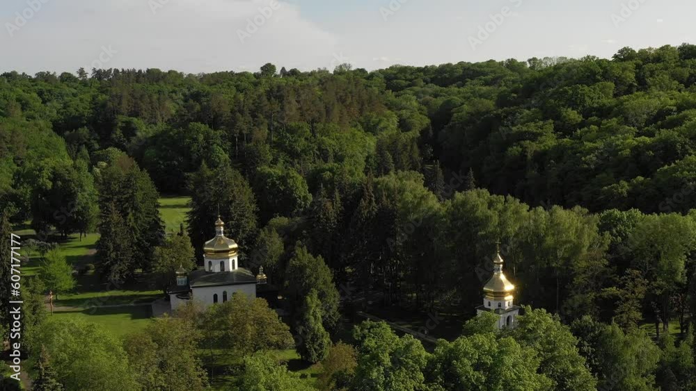 Summer time nature panoramic landscape, mountain in front of church, Aerial drone footage. Old church near Lake Bled from the air on sunny day. Beautiful landscape with blue water and forest around