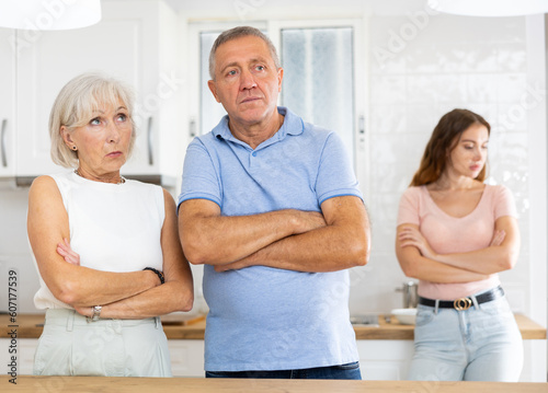 Upset and unhappy father standing in the kitchen separately, family conflict