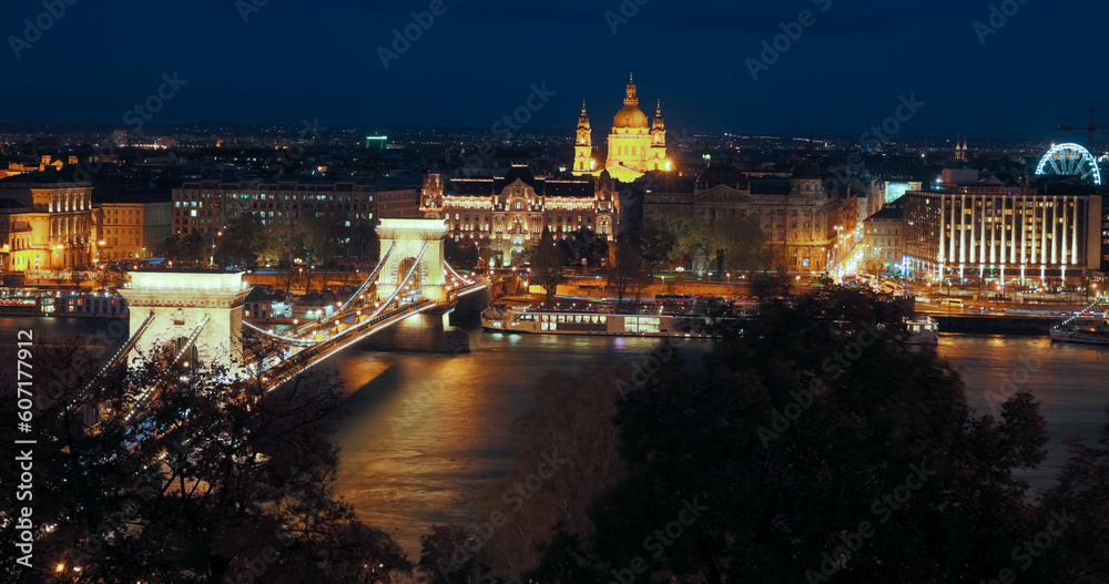 Chain Bridge and Parliament in night light of Budapest outdoors.