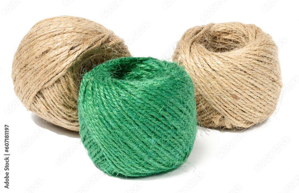 Brown and green skeins of jute rope on a white isolated background Brown and green skeins of jute rope on a white isolated background