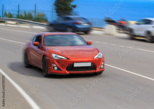 Red sports car rushes along the highway © Yuri Bizgaimer