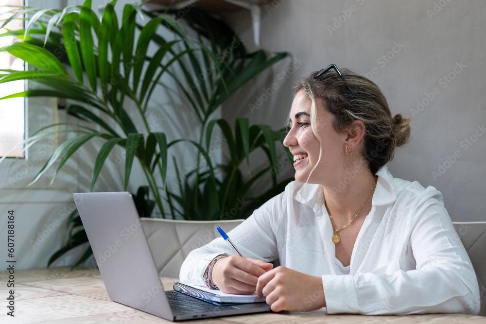 Portrait of smiling millennial caucasian female student sit at desk at home study online on laptop. Happy young cheerful woman use computer take distant course or training. Education concept.. Portrait of smiling millennial caucasian female student sit at desk at home study online on laptop. Happy young cheerful woman use computer take distant course or training. Education concept..