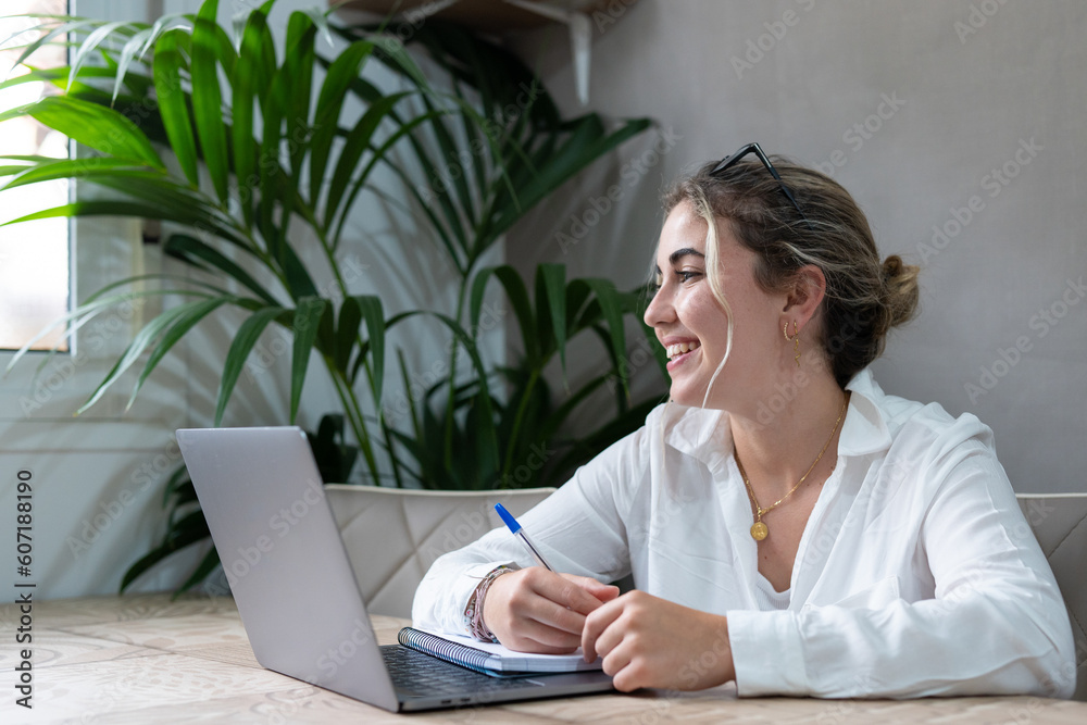 Portrait of smiling millennial caucasian female student sit at desk at home study online on laptop. Happy young cheerful woman use computer take distant course or training. Education concept.. Portrait of smiling millennial caucasian female student sit at desk at home study online on laptop. Happy young cheerful woman use computer take distant course or training. Education concept..