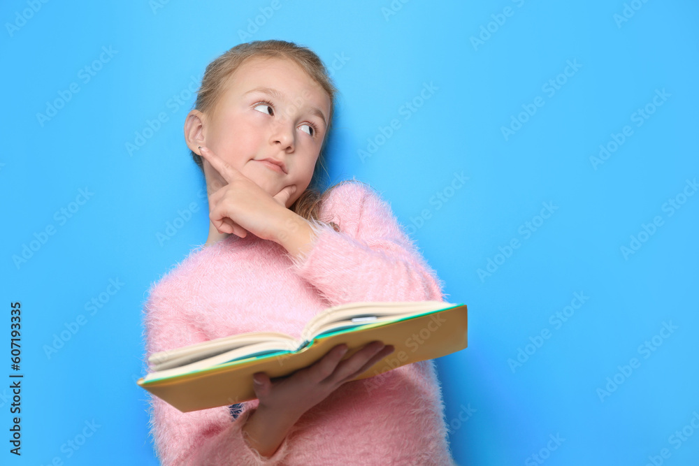 Little girl with book on light blue background. Space for text Little girl with book on light blue background. Space for text