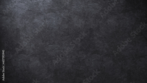 Elegant background texture of a dark stone surface softly lit from one side