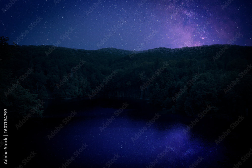 Amazing starry sky reflecting in lake. Beautiful night landscape