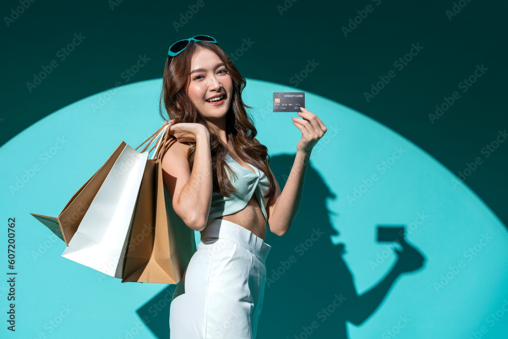 Φωτογραφία Asian happy female woman girl holds colourful shopping packages   standing on bl