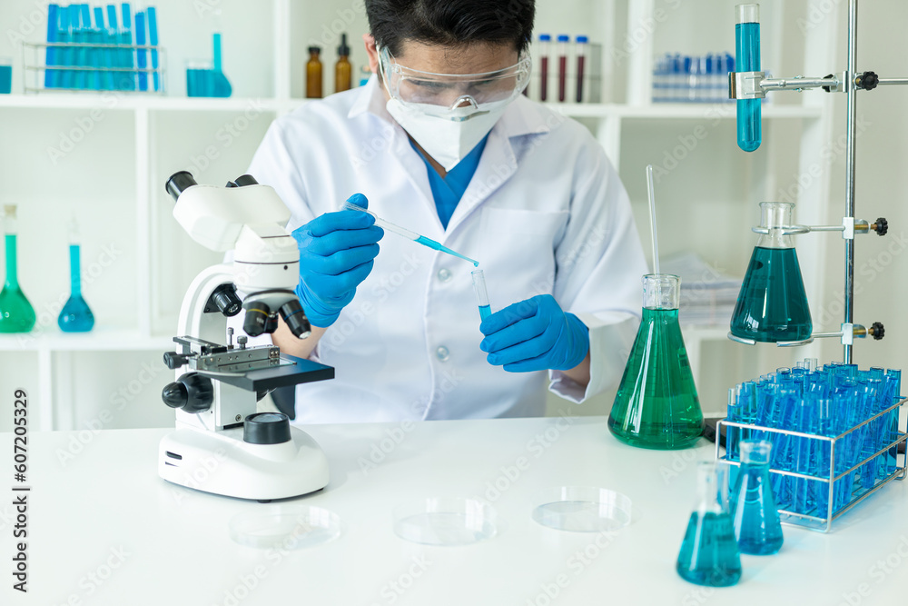 Researcher with chemical test tubes in a glass laboratory with liquid for analytical, medical, pharmaceutical and scientific research concepts Test tubes in medical research clinics and chemicals Researcher with chemical test tubes in a glass laboratory with liquid for analytical, medical, pharmaceutical and scientific research concepts Test tubes in medical research clinics and chemicals
