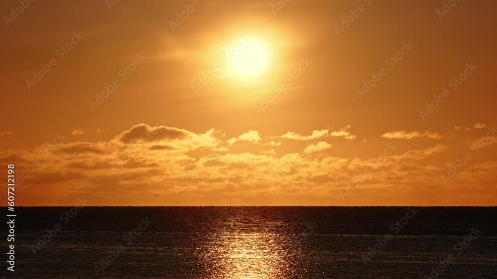 Warm clouds over pure ocean water at sunrise or sunset. Nature seascape shot in 8k resolution. Warm clouds over pure ocean water at sunrise or sunset. Nature seascape shot in 8k resolution.