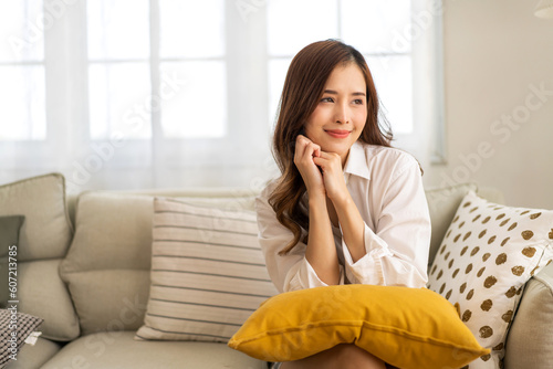 Portrait of smiling cheerful beautiful pretty asian woman clean fresh healthy white skin posing smile in pajamas white clothes.Girl felling relax and enjoy time on sofa at home.asia beauty