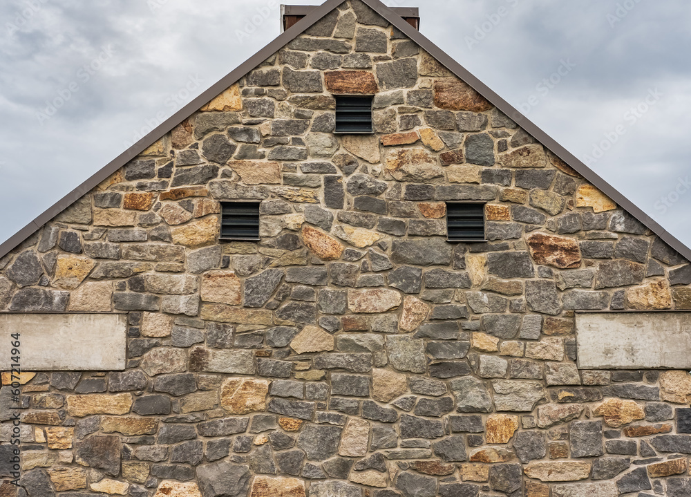 View of a Traditional Old Stone House in a rural Countryside. Top of Traditional ancient hut stone house