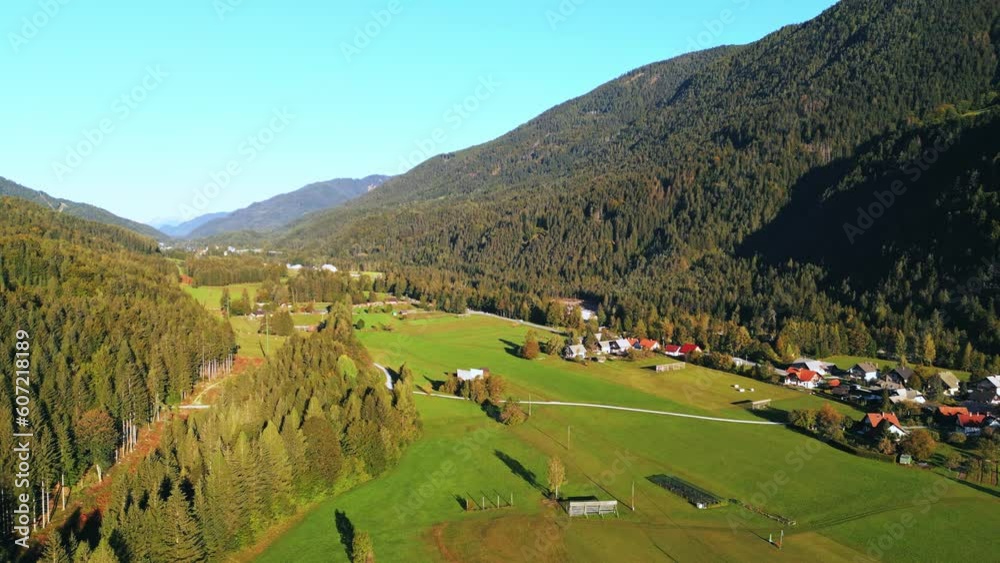 Beautiful Green Valley in the Julian Alps in Slovenia and Italy with a road and small village of houses Beautiful Green Valley in the Julian Alps in Slovenia and Italy with a road and small village of houses