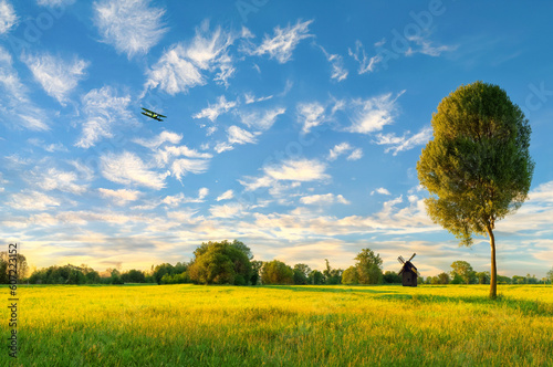 The plane is flying over the vast grassland.