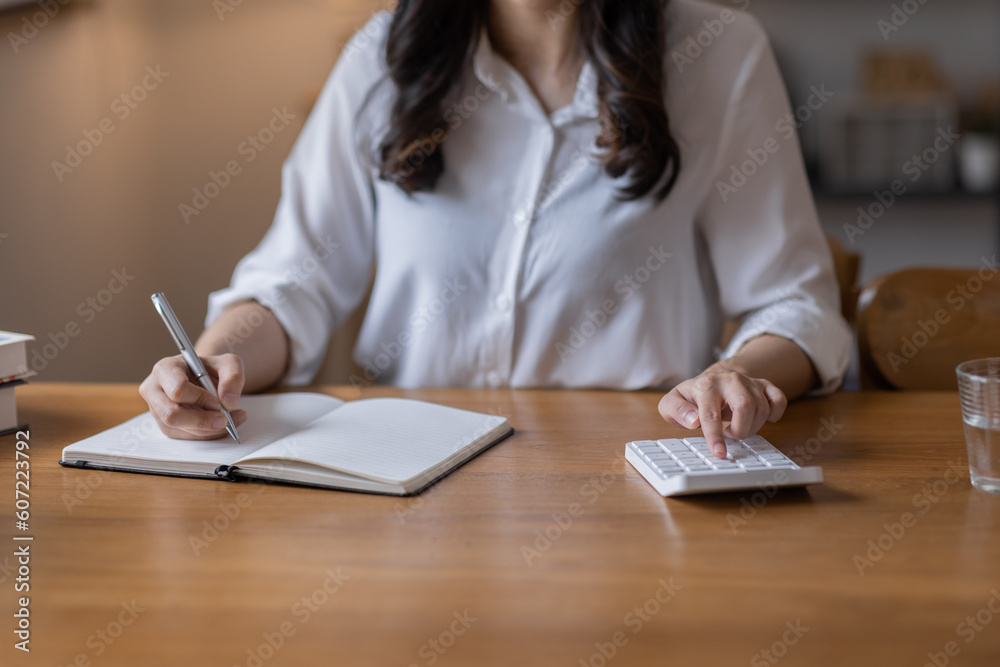 Closeup hands of businessman working on desk office with using a calculator to calculate the numbers, finance accounting concept
