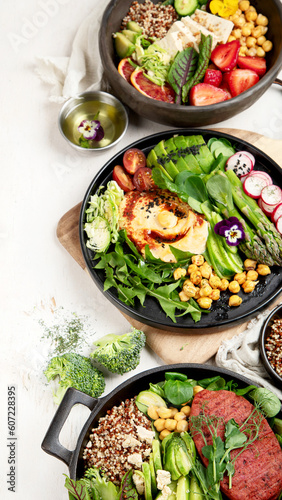 Healthy vegetarian and vegan salads and Buddha Bowls with vitamins, antioxidants, protein on light background.