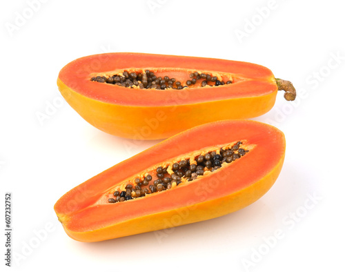 half of ripe papaya fruit with seeds on white background.