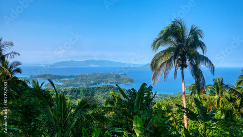 Wide angle view of the Philippines coastal resort area of Puerto Galera on Mindoro Island, the Verde Island Passage, and Luzon Island in the distance.