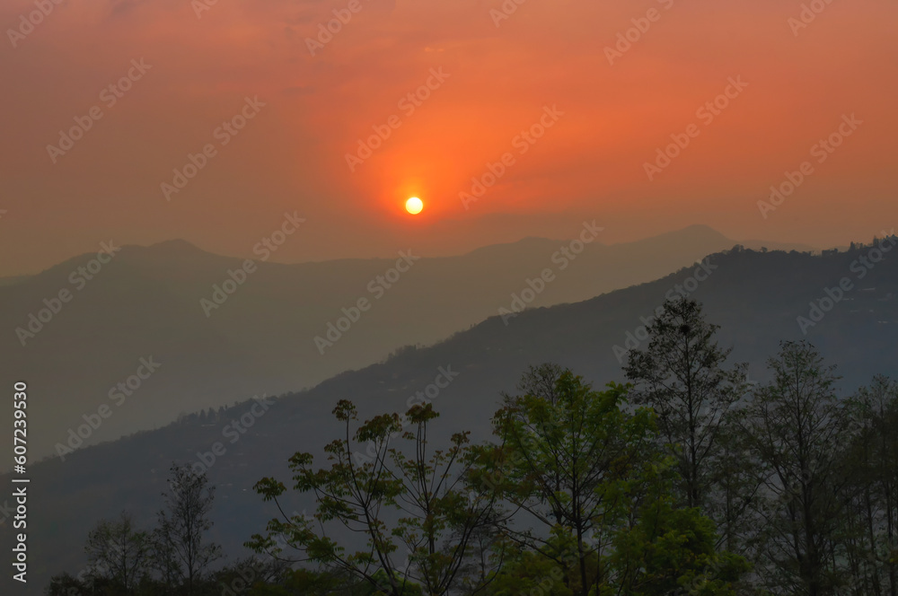 Beautiful sunrise in mountains of Himalayas, Hee Barmiok village of Sikkim, India. Great Himalayan mountain peaks in the background.