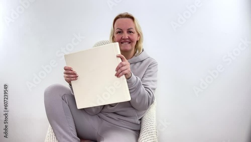 Older woman holding white cardboard. High quality photo photo
