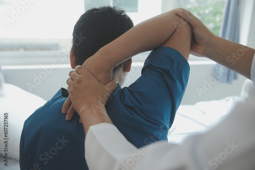 Professional orthopedist examining little patient's leg in clinic photo