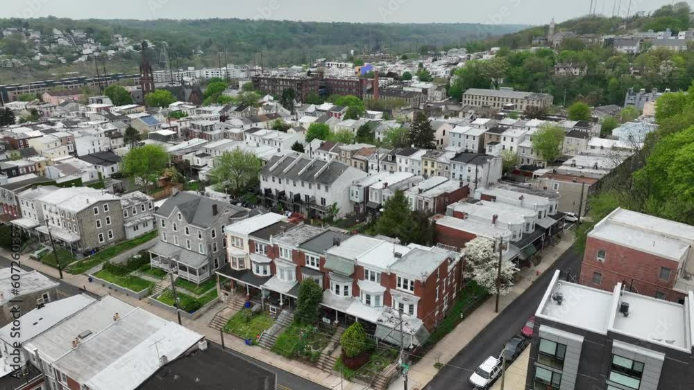 Row houses in American city suburb in spring. Aerial orbit establishing shot on cloudy day. Row houses in American city suburb in spring. Aerial orbit establishing shot on cloudy day.