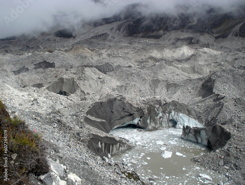 A view of debris and snow mix Rathong glacier looks like a bombarded area in Sikkim. It is about 26 km located on the base of Mt. Kanchenjunga which is melting faster than the other Himalayan region.  photo