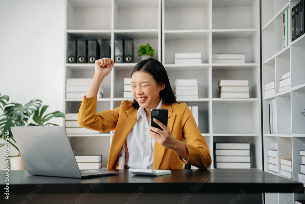 Asian business woman are delighted and happy with the work they do on their tablet, laptop and taking notes at office. Asian business woman are delighted and happy with the work they do on their tablet, laptop and taking notes at office.