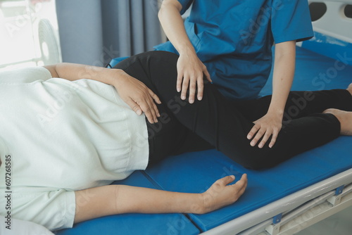 Physiotherapist working with patient in clinic  closeup
