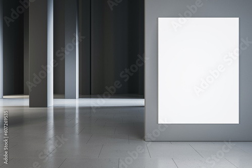 Front view on blank white poster with space for logo or advertising text on grey partition in abstract industrial hall with concrete lighting pillars on glossy ceramic tile floor. 3D rendering, mockup