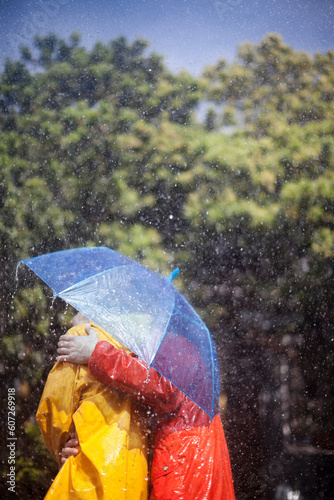 Couple hugging under umbrella in rain