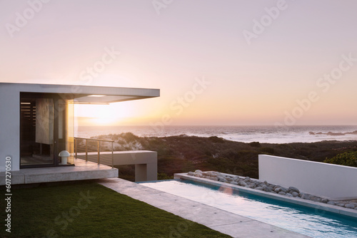 Modern house overlooking ocean at sunset