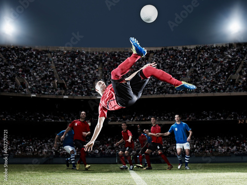 Soccer player kicking ball on field photo