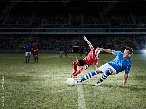 Soccer players kicking for ball on field © KOTO